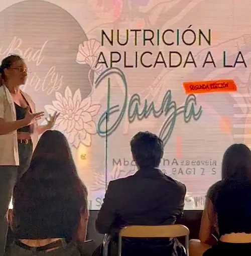 Nutricionista en una charla con un grupo de bailarines